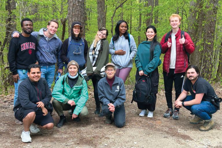 Professor Meretsky and students in front of forest.